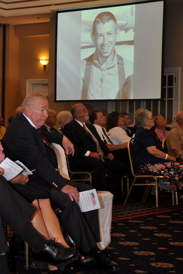 Col. William G. Swarens (Ret.) is honored in a slide show presentation presented by his daughter Laura McGlamery, during Swarens’ retirement ceremony July 30 at the Clubs at Quantico. McGlamery shares a photo of her father’s first solo flight as an Aviation Cadet in 1966.