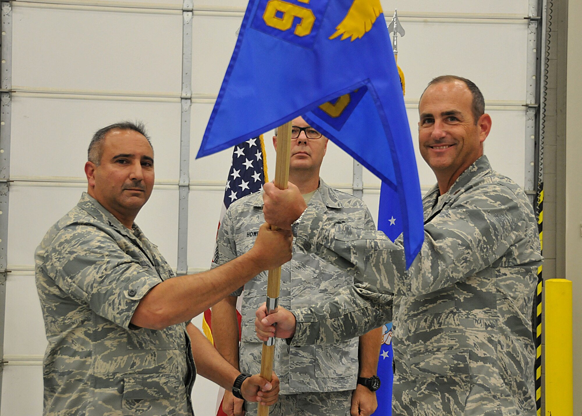 Maj. Steven Fortson receives the unit flag from Col. Augusto Casado, commander of the 94th maintenance group, during the change of command ceremony Aug. 2, 2015 at Dobbins Air Reserve Base, Ga. Maj. Fortson was appointed as the new commander of the 94th Aircraft Maintenance Squadron. (U.S. Air Force photo/Senior Airman Andrew Park)