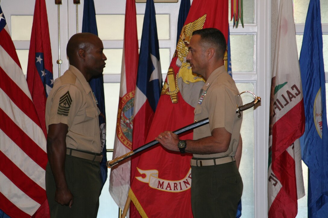 On July 31, Commanding Officer of Marine Corps Base Quantico, Col. Joseph M. Murray (right) passed the United States Marine Corps noncommissioned officers sword to Sgt. Maj. Mark A. Byrd Sr. (left) during the relief and appointment ceremony held at the Clubs at Quantico. Sgt. Maj. Gerald A. Saunders Jr. will be replacing Byrd as the Sgt. Maj. of Marine Corps Base Quantico.