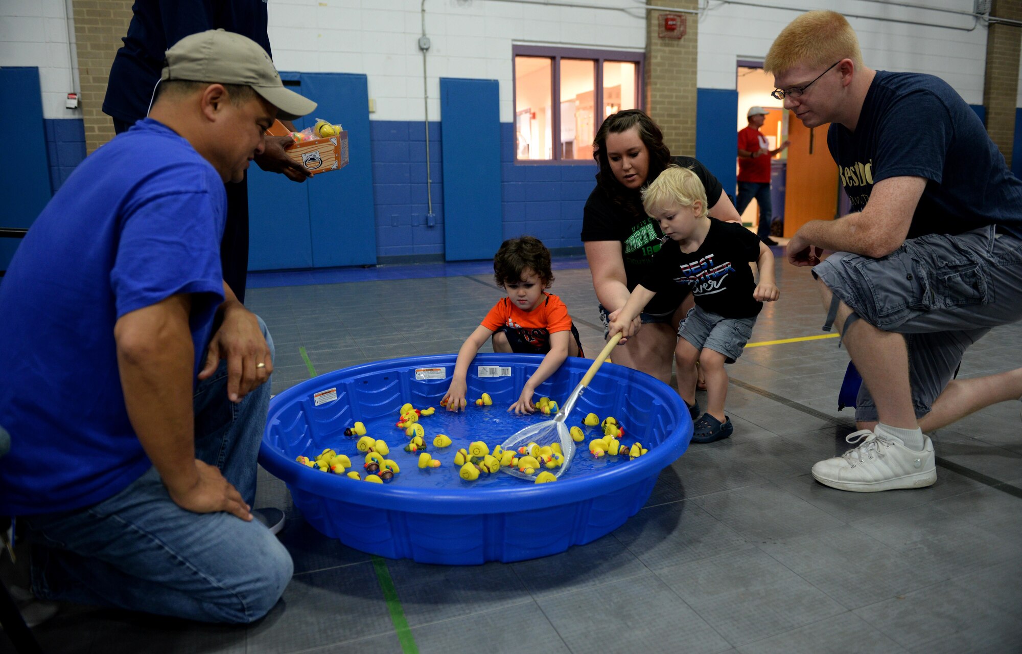 Hunter and Jaxon Hummel, sons of Staff Sgt. Matthew Hummel 81st Logistics Readiness Squadron vehicle operator, catch rubber ducks at a play area during the Exceptional Family Member Program Information and Resource Fair, Aug. 1, 2015, Keesler Air Force Base, Miss. EFMP, with help from Keesler Integrated Resource Team organizations, provided carnival games, hands-on activities and information about support programs to families with special needs dependents. (U.S. Air Force photo by Senior Airman Holly Mansfield)