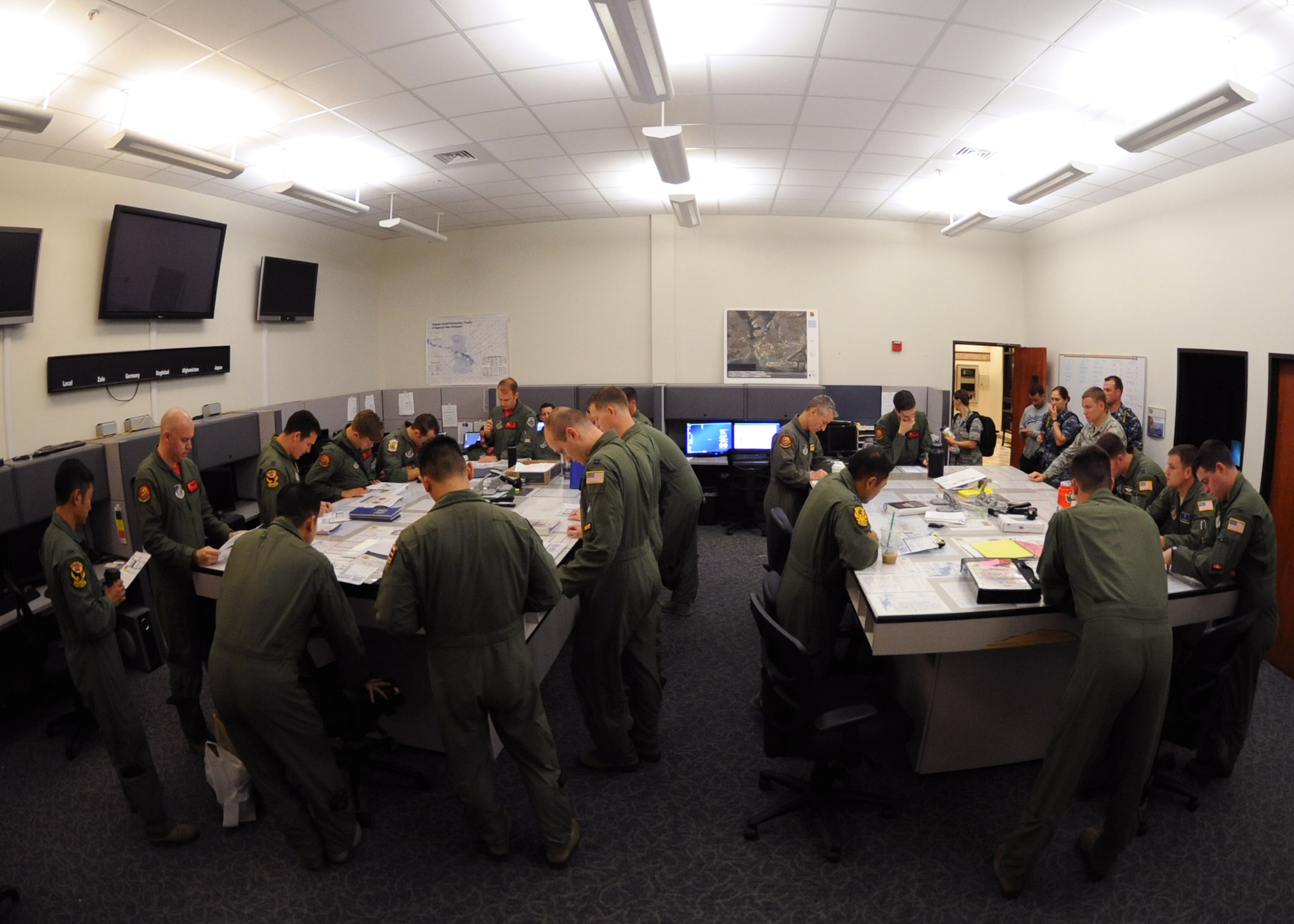U.S. Air Force aircrew from the 535th Airlift Squadron conduct a pre-mission briefing on Joint Base Pearl Harbor-Hickam, Hawaii, July 31, 2015. Active duty and Air National Guard Airmen joined forces in a Warrior Day to demonstrate the cooperation and capabilities of total force integration. During the Warrior Day training, five C-17 Globemasters III simulated combat maneuvers in a hostile environment, airdrops, and refueling operations. (U.S. Air Force photo by Tech. Sgt. Aaron Oelrich/Released)
