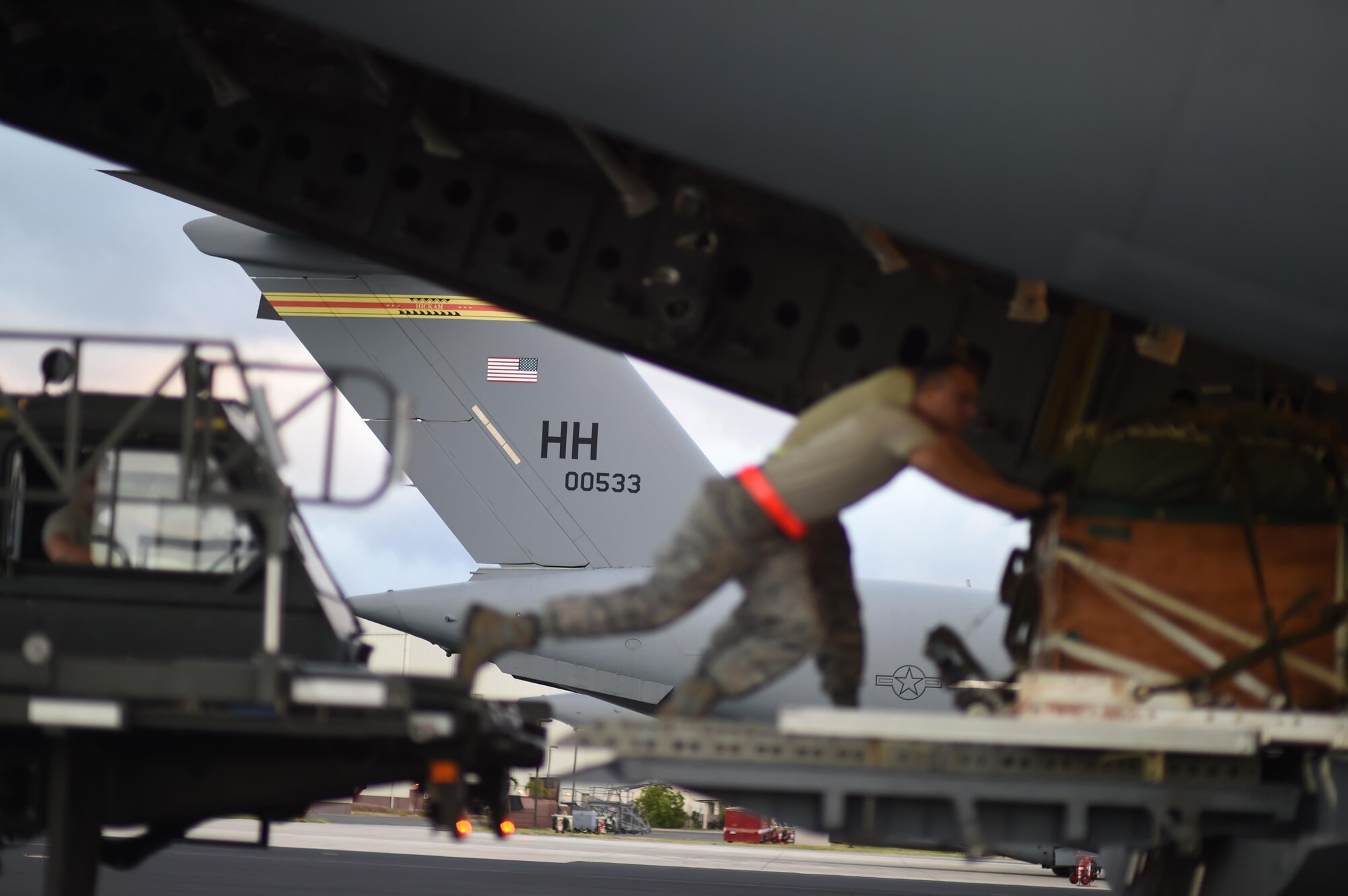 U.S. Air Force Airmen from the 647th Logistics Readiness Squadron delivering a combat delivery system to be airdropped from a U.S. Air Force C-17 Globemaster III from the 535th Airlift Squadron during Warrior Day on Joint Base Pearl Harbor-Hickam, Hawaii July 31, 2015. The day featured the participation of 15th Wing C-17 Globemasters III and F-22 Raptors of the 199th fight squadron, as well as KC-10 Extenders from Travis Air Force Base, California, and tested the ability for the aircrafts and personnel to work together to complete a mission. (U.S. Air Force photo by Tech. Sgt. Aaron Oelrich/Released)
