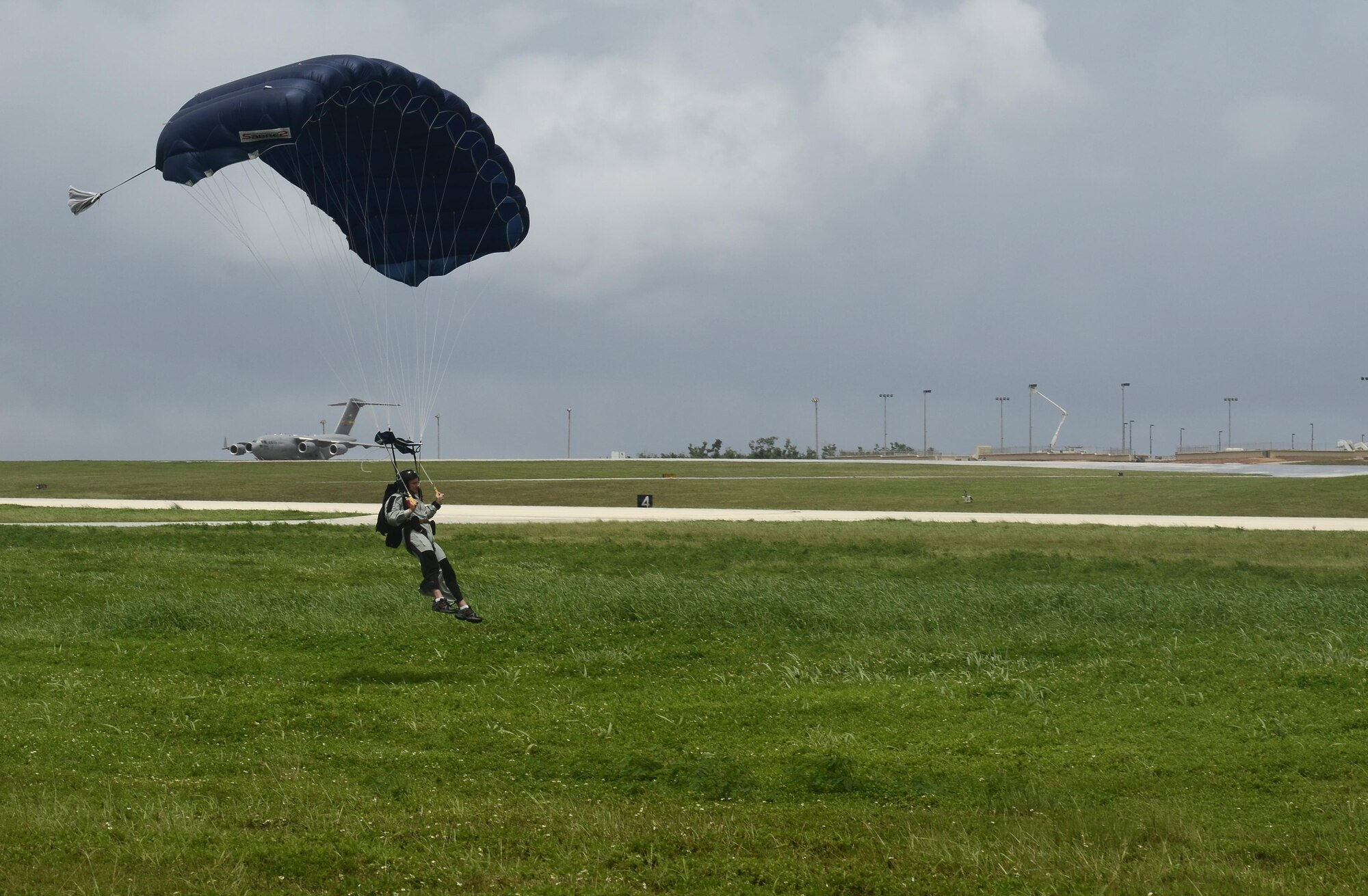 A U.S. service member prepares for a parachute landing Aug. 4, 2015 at Andersen Air Force Base, Guam. Airmen, Sailors and Marines assigned to Joint Region Marianas took part in regular proficiency training to keep their airborne skills up to date and remain prepared for real-world missions. (U.S. Air Force photo by Airman 1st Class Alexa Ann Henderson/Released)