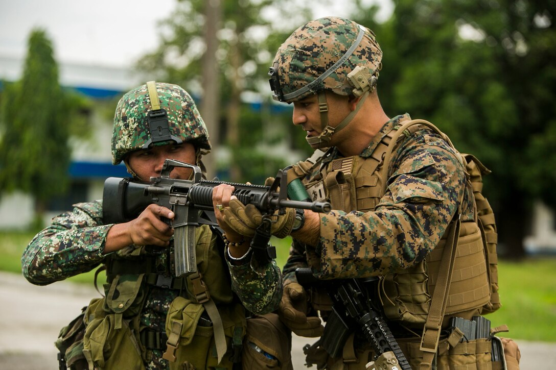 U.S. Marine Corps 1st Lt. Matt Shibata teaches a Philippine Marine proper weapon handling techniques during Air Assault Support Exercise 2015-2 at Basa Air Base in Pampanga, Philippines, July 15, 2015. The Marines went through a number of different scenarios to include fire and maneuver as well as urban operations. AASE is a bilateral training event focused on strengthening the alliance between the Philippines and the U.S. Shibata is the platoon commander with 2nd Platoon, Fox Company, 2nd Battalion, 3rd Marine Division and is attached through the Unit Deployment Program to III Marine Expeditionary Force. The Philippine Marines are with Marine Battalion Landing Team 1, 1st Battalion, Philippine Marine Corps. 