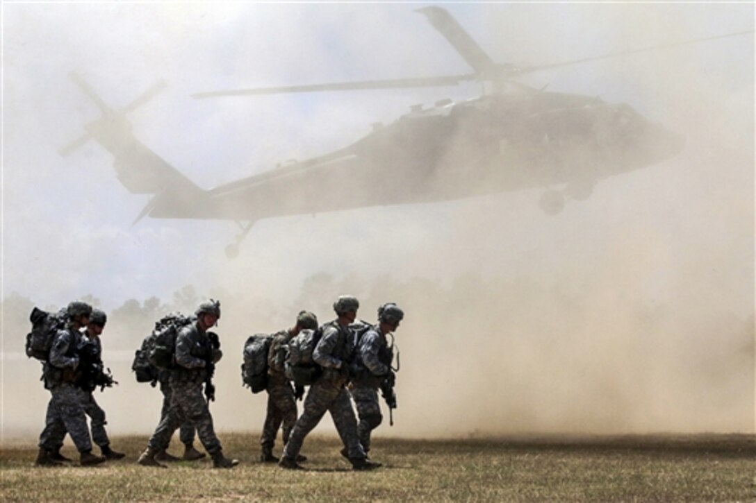 Paratroopers move to their loading zone as rotor wash from a UH-60 Black Hawk caused a dust cloud during Operation Red Fury on Fort Bragg, N.C., Aug. 4, 2015. The training helped to increase the unit’s interoperability between ground and aviation units. The paratroopers are assigned to the 82nd Airborne Division's 1st Battalion, 508th Parachute Infantry Regiment, 2nd Brigade Combat Team.