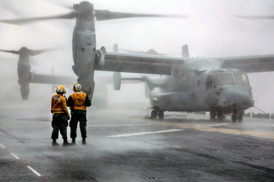Sailors discuss flight operations on the USS Kearsarge in the Atlantic Ocean, Aug. 4, 2015. The Kearsarge Amphibious Ready Group and the 26th Marine Expeditionary Unit are preparing for an upcoming deployment.