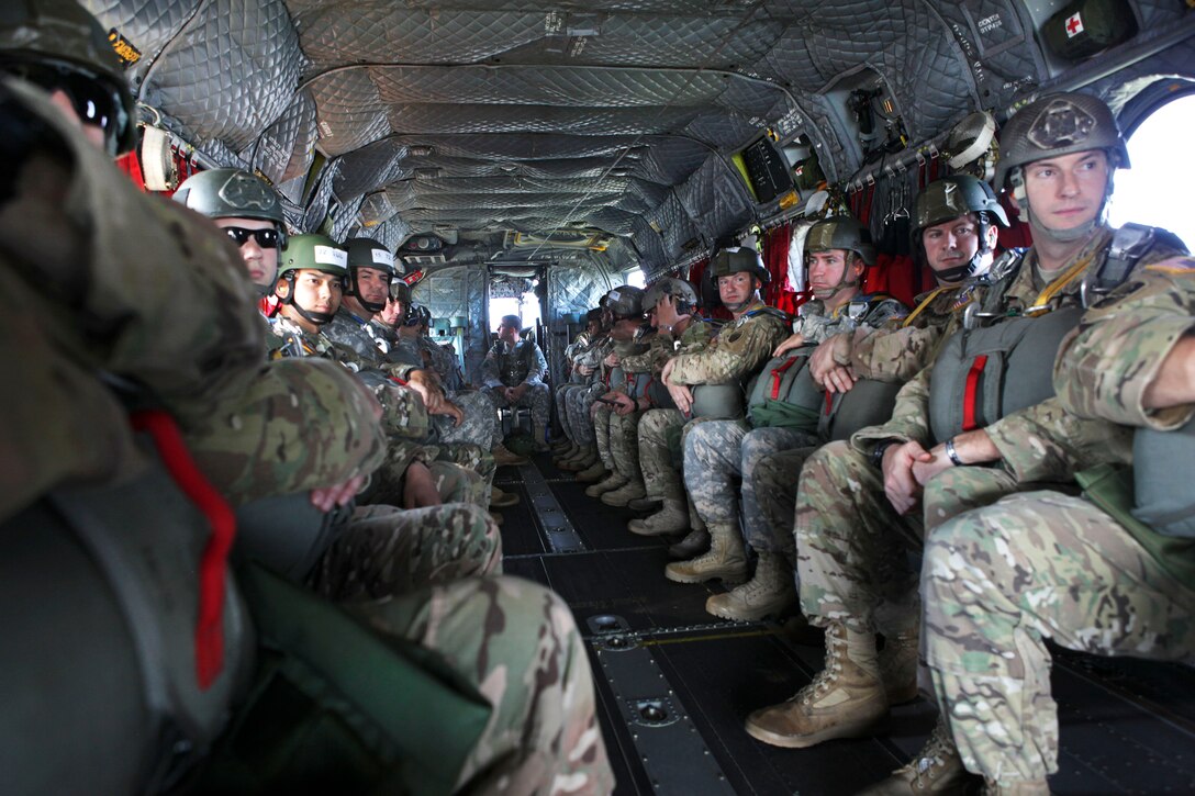 U.S. paratroopers sit inside a CH-47 Chinook helicopter to participate in airborne operation during Leapfest 2015 in West Kingston, R.I., Aug. 1, 2015. The exercise is an international parachute competition hosted by the Rhode Island Army National Guard’s 56th Troop Command to promote high-level technical training and esprit de corps within the international airborne community.