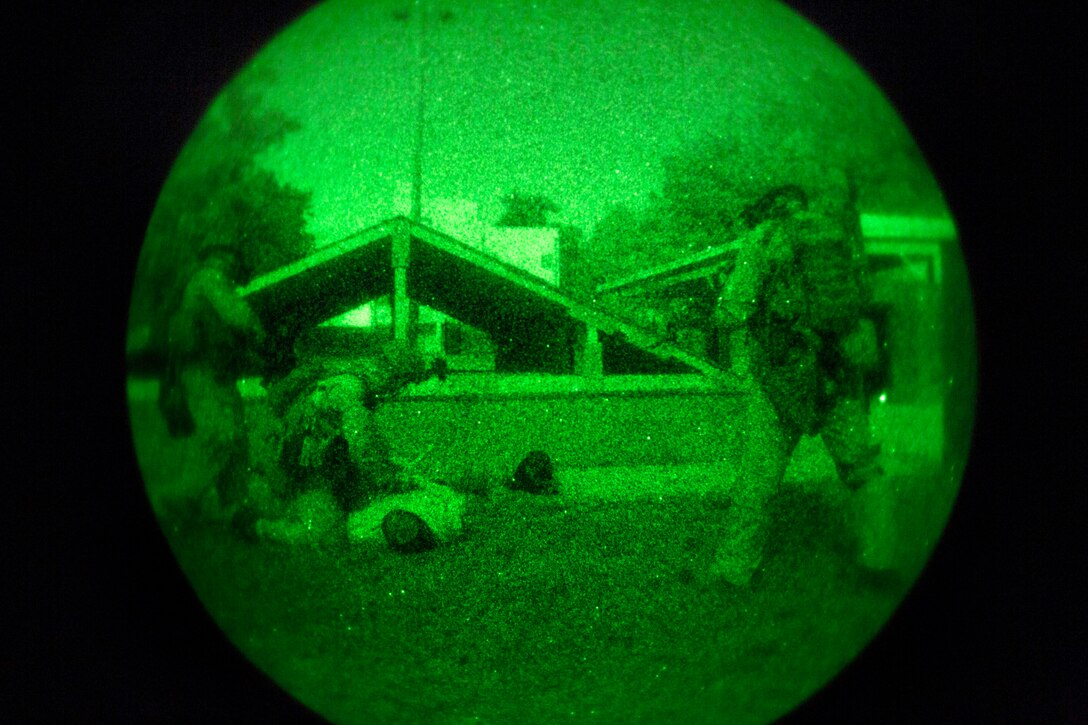 As seen through a night-vision device, Marines detain role players ...