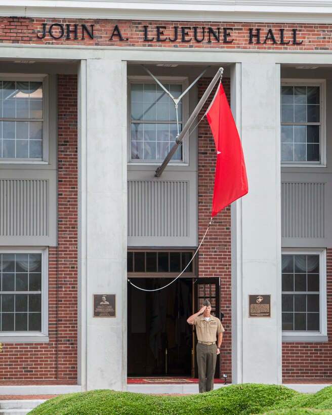 U.S. Marine Corps Chief Warrant Officer 3 Randall Howell, the command duty officer for Marine Corps Installations East-Marine Corps Base Camp Lejeune, renders honors as the American flag is raised during morning colors on Camp Lejeune, N.C., Aug. 4, 2015. 