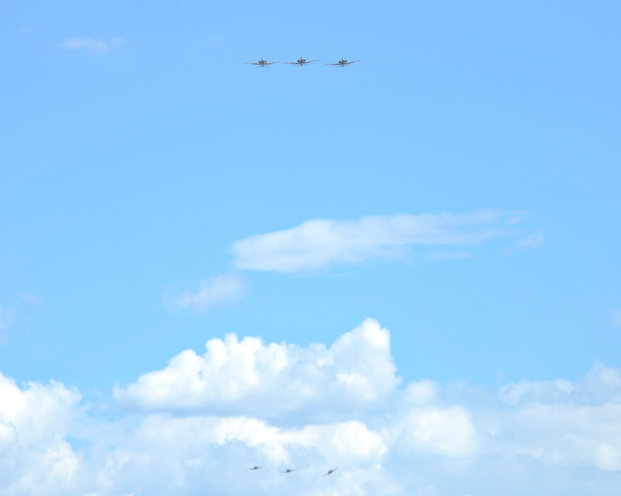 Two sets of three U.S. Air Force A-10C Thunderbolt IIs from the 354th Fighter Squadron fly in formation over Davis-Monthan Air Force Base, Ariz., Aug. 4, 2015. Twelve A-10s and their pilots from the 354th FS returned after a 6-month-long deployment to Europe where they flew over 1,500 missions throughout 21 countries as part of the Theater Security Package to Europe in support of Operation Atlantic Resolve. (U.S. Air Force photo by Senior Airman Chris Massey/Released)