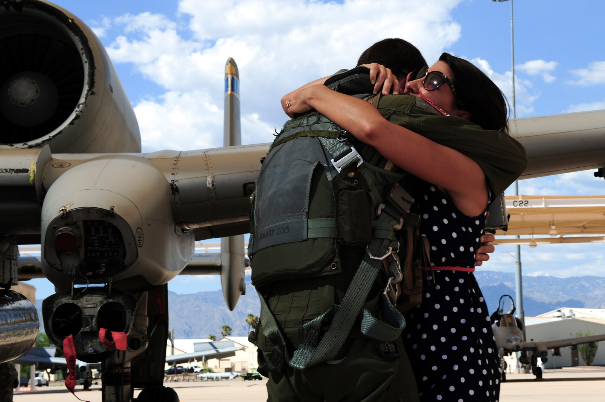 U.S. Air Force Capt. Eric Smith, 354th Fighter Squadron A-10C pilot, hugs his wife Emily Smith on the flightline at Davis-Monthan Air Force Base, Ariz., after returning from a deployment to Europe August 4, 2015. While deployed, the 354th FS participated in 21 exercises, compiling more than 1,500 flying missions and nearly 2,700 flight hours while engaging with 22 countries. (U.S. Air Force photo by Airman 1st Class Chris Drzazgowski/Released)