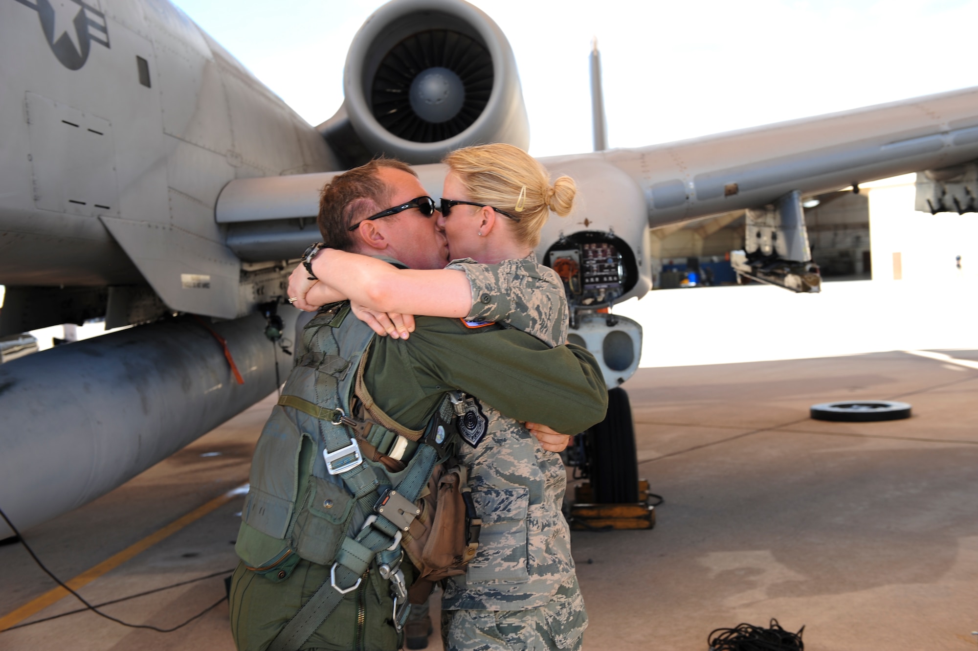 U.S. Air Force Lt. Col. Ryan Hayde, 354th Fighter Squadron commander, kisses his wife Maj. Erin Hayde, 612th Air and Space Operations Center intel officer,on the flightline at Davis-Monthan Air Force Base, Ariz., after returning from a 6-month-long deployment August 4, 2015. The 354th FS was deployed to the first European Theater Security Package in support of Operation Atlantic Resolve. (U.S. Air Force photo by Airman 1st Class Chris Drzazgowski/Released)