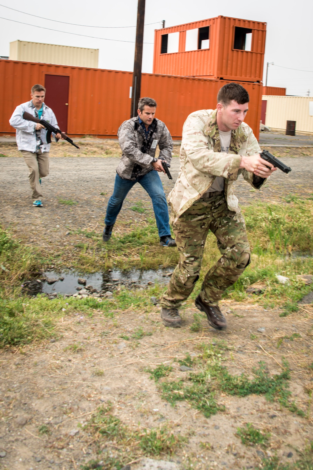 Senior Airman Alan Hamilton, 22nd Training Squadron Survival, Evasion, Resistance and Escape specialist, leads U.S. Representative and Illinois Air National Guard Maj. Adam Kinzinger during an urban evasion tactics familiarization demonstration as part of the representative’s visit Aug. 3, 2015, at Fairchild Air Force Base, Wash. During his visit, the congressman explained to each Airman their importance to not only the Air Force’s mission, but America as a whole and thanked them for their service. (U.S. Air Force photo/Staff Sgt. Benjamin W. Stratton)