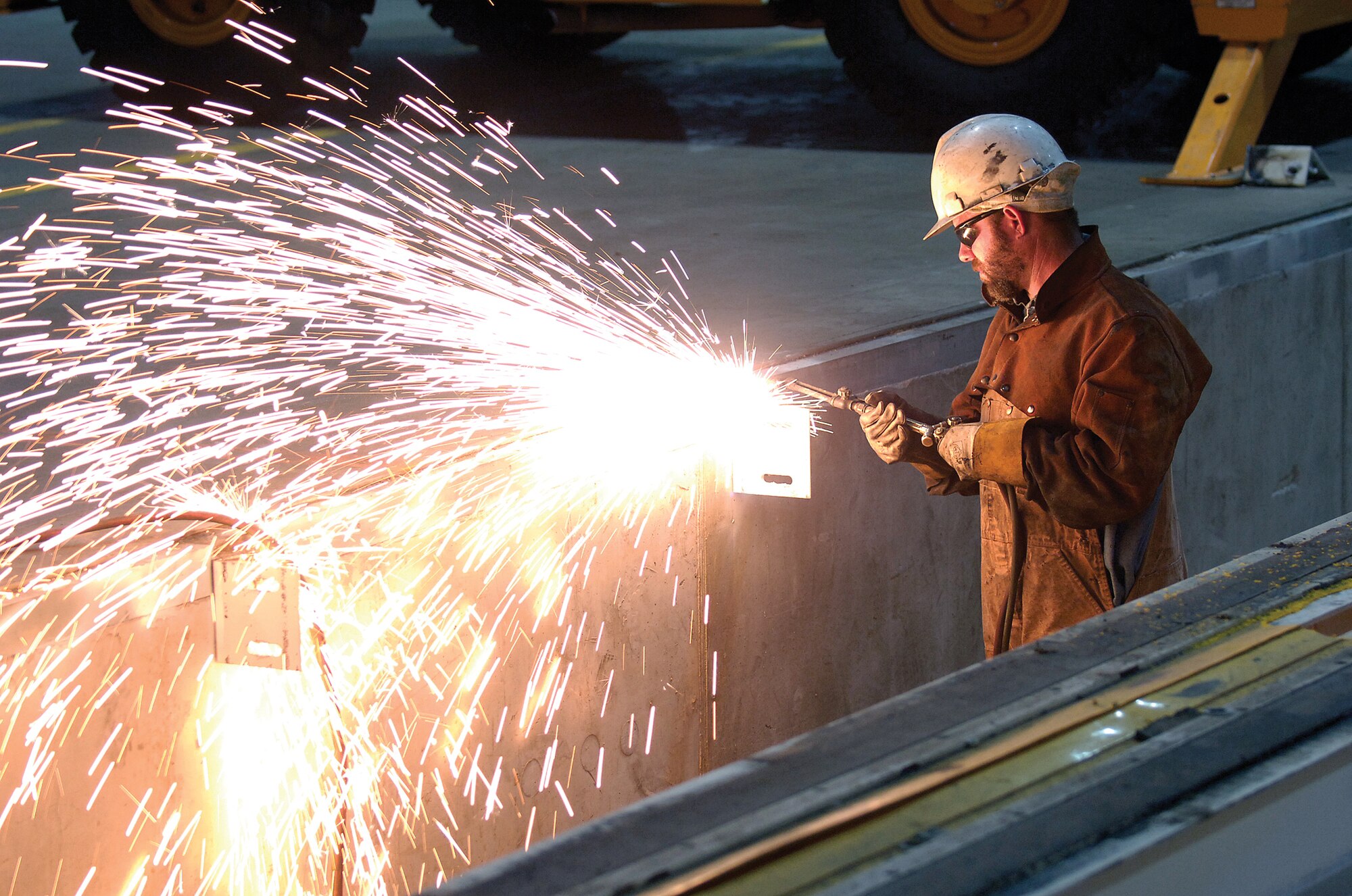 A welder works in Building 9001 of the Oklahoma City Air Logistics Complex at Tinker Air Force Base, Oklahoma. The Defense Logistics Agency Energy, in conjunction with the Air Force Civil Engineer Center, recently announced the energy service company chosen to move forward with an energy savings performance contract, or ESPC, at the complex. (U.S. Air Force photo/Margo Wright/Released)