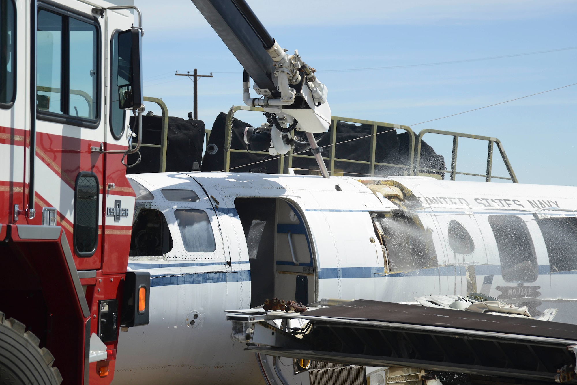 Water is sprayed from the penetrating boom, spraying into the aircraft. (U.S. Air Force photo by Patric Lovato)