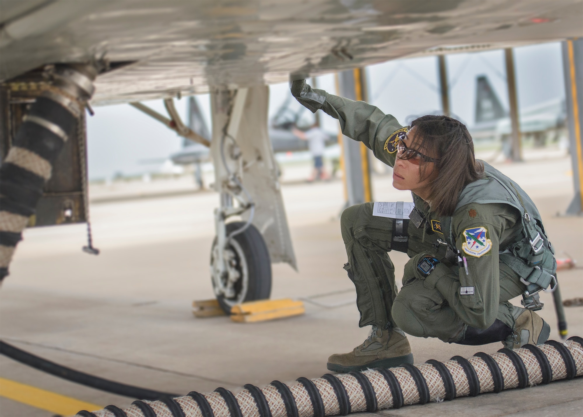 Maj. Christina Hopper conducts a comprehensive check of her T-38 Talon on the flightline at Vance Air Force Base, Oklahoma, July 20. (U.S. Air Force photo / David Poe)