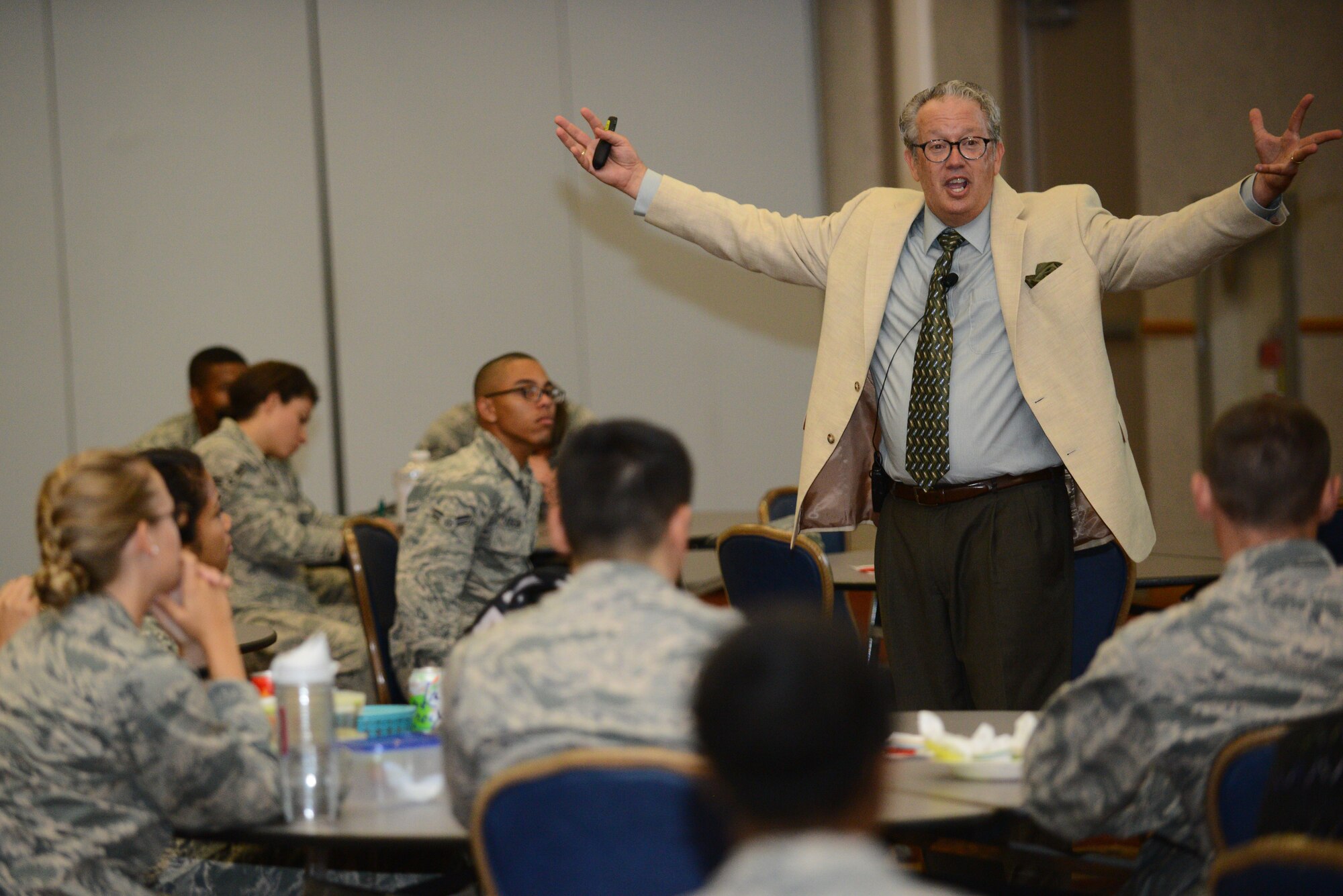 Dr. Paul White, psychologist and author, speaks to Airmen about how to deal with dysfunctional colleagues, Aug. 5, 2015, at McConnell Air Force Base, Kan. White is one of 15 speakers scheduled to talk to Team McConnell members about topics ranging from success to returning about adversity during #theSUMof15. “From a supervisor’s point of view, the best thing to do is learn how to manage yourself around dysfunctional people,” said White. (U.S. Air Force photo by Airman 1st Class Christopher Thornbury)