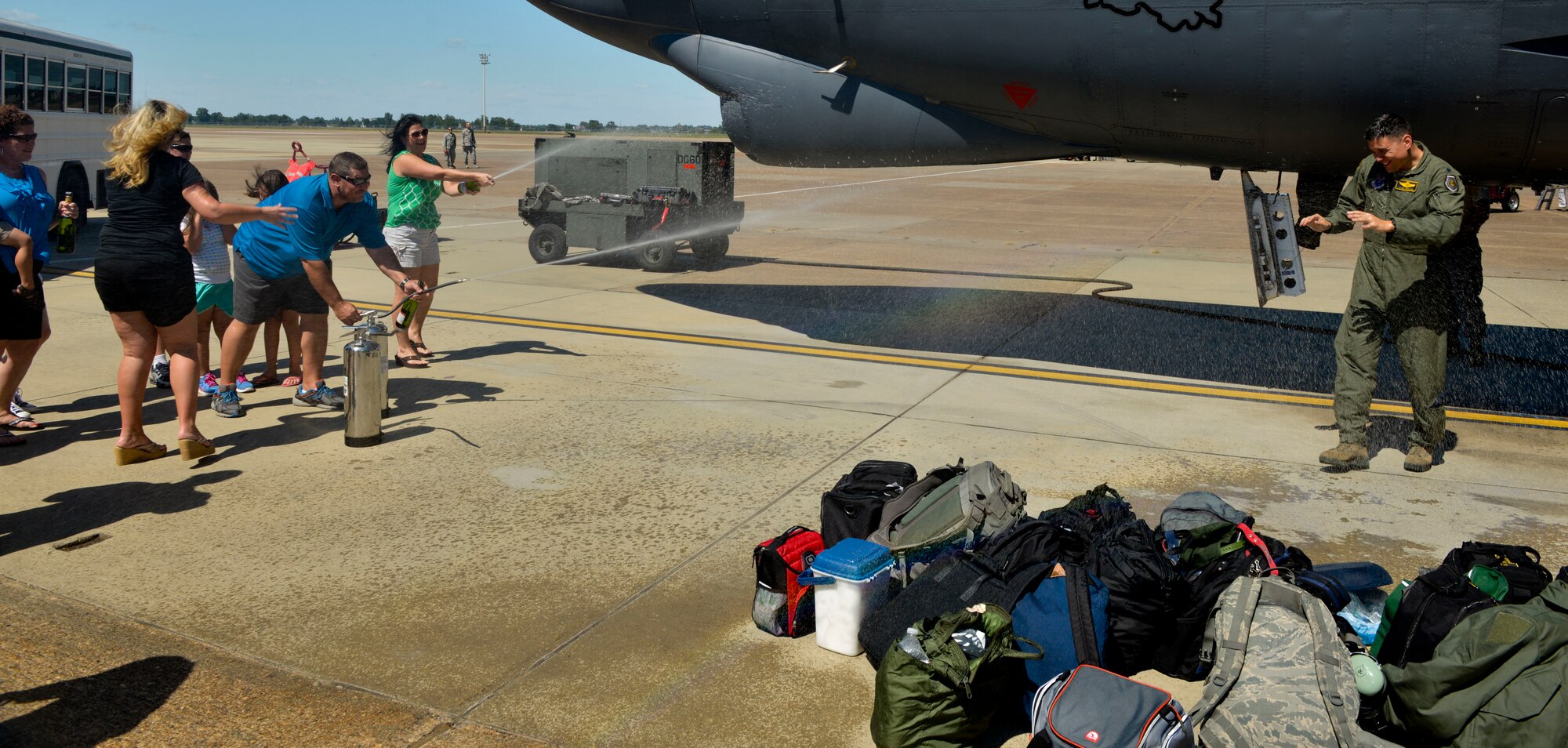 A B-52 aircrew member is sprayed with water at Barksdale Air Force Base, La., Aug. 1, 2015 after arriving home from a mission. The B-52 bomber fleet provides decision makers the ability to rapidly project military and deliver decisive effects to fulfill our security requirements. (U.S. Air Force photo/Airman 1st Class Mozer O. Da Cunha) 
