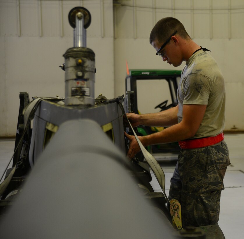 Airman 1st Class Jeremiah Hatcher, 22nd Maintenance Squadron aircraft hydraulics specialist, attaches a panel to a KC-135 Stratotanker boom, July 28, 2015 at McConnell Air Force Base, Kan. Panels were attached during a temporary rebuild of the boom to prevent damages during shipment sent off to another base for repair. (U.S. Air Force photo by Airman 1st Class Christopher Thornbury)