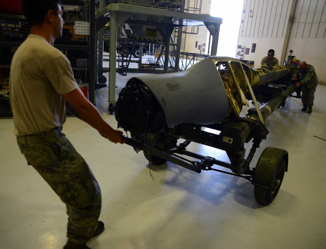 Airmen from the 22nd Maintenance Squadron hydraulics shop, reposition a KC-135 Stratotanker boom, July 28, 2015, at McConnell Air Force Base, Kan. The boom was temporarily rebuilt and was sent to another base for a complete rebuild. The boom is essential for aerial refueling of other military aircraft to enable warfighting capability. (U.S. Air Force photo by Airman 1st Class Christopher Thornbury)