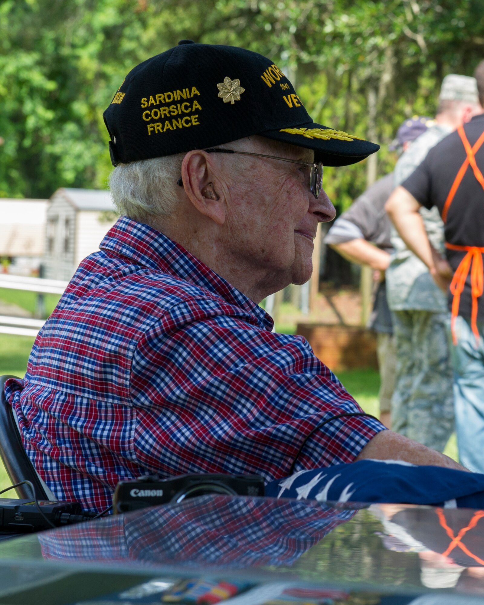Jules Olivier, Army Air Corps and Air Force veteran, sits after receiving an American flag flown over Tyndall July 31 at his house.  Panama City’s Home Depot installed a flag pole for Olivier free of charge, and members of Team Tyndall presented him with an American flag that had been flown over Tyndall. (U.S. Air Force photo by Senior Airman Alex Echols/Released)