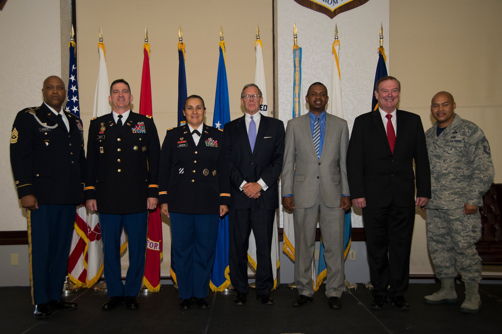 Previous commanders and the current commander pose for a photo at the Scott Club, July, 31, 2015, at Scott Air Force Base, Illinois. Defense Information Systems Agency's goal is to ensure the Defense Switched Network and its interfacing components maintain an appropriate level of security that ensures confidentiality, integrity, authentication, non-repudiation, and availability for the network as a whole. (U. S. Air Force photo by Airman 1st Class Melissa Estevez)