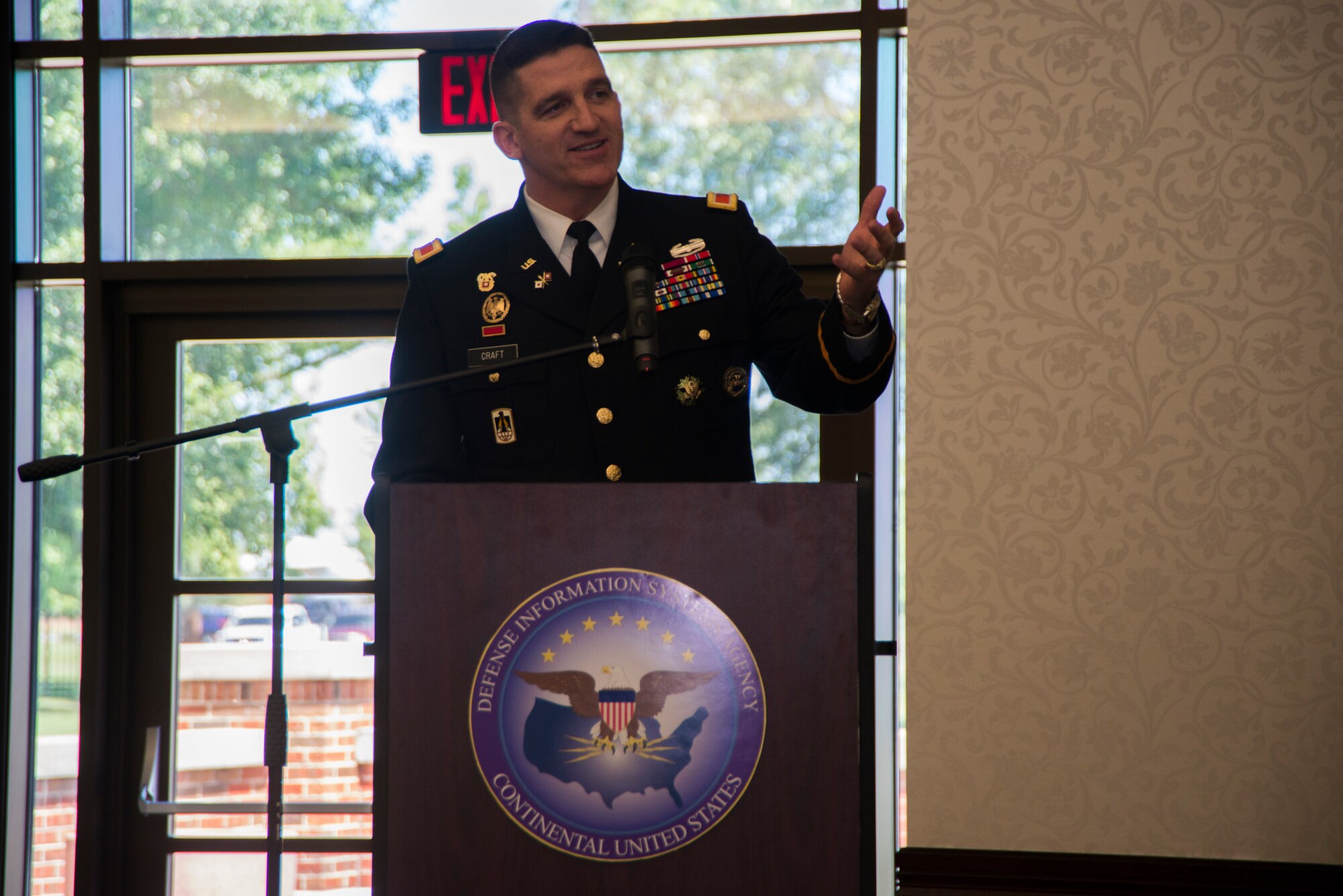 Col. Paul Craft, Defense Information Systems Agency commander, speaks to members of his organization for the first time as commander at the Scott Club, July, 31, 2015, at Scott Air Force Base, Illinois. Craft said, “I know I have big shoes to fill, I am certainly excited and I am looking forward to this opportunity to lead the finest civilians, contractors and service members that we have here at DISA CONUS.” (U. S. Air Force photo by Airman 1st Class Melissa Estevez)
