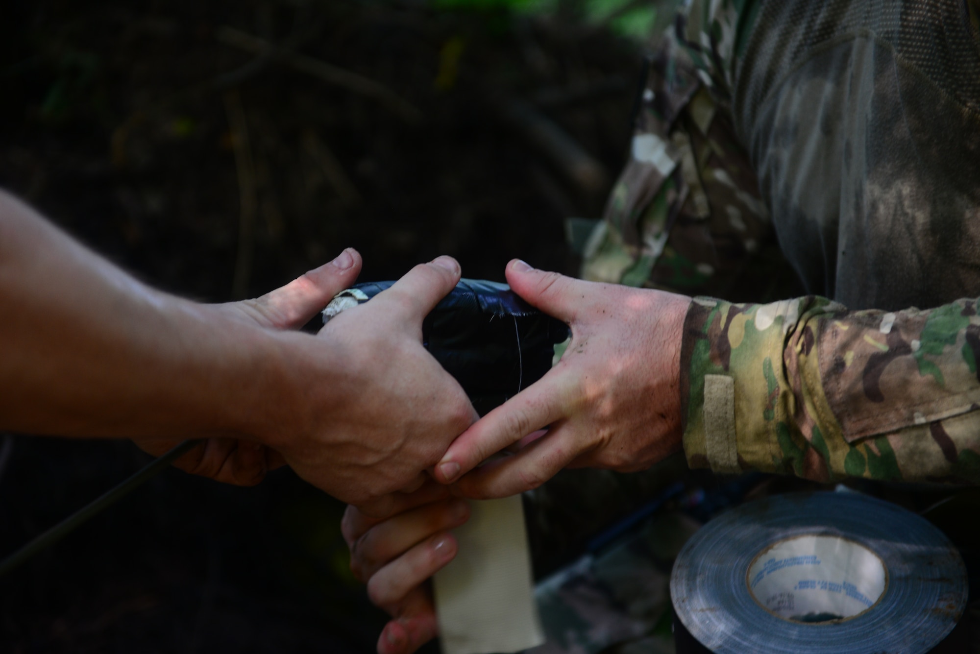 Senior Airman Donal Mesa, left, and Staff Sgt. Jordan Burger, 2nd Civil Engineer Squadron explosive ordnance disposal technicians, prepare C-4 explosives for detonation in the east reservation woods at Barksdale Air Force Base, La., July 29, 2015. C-4 plastic explosives combine explosive chemicals with a plastic binder material to make it malleable. (U.S. Air Force Photo/Airman 1st Class Luke Hill)
