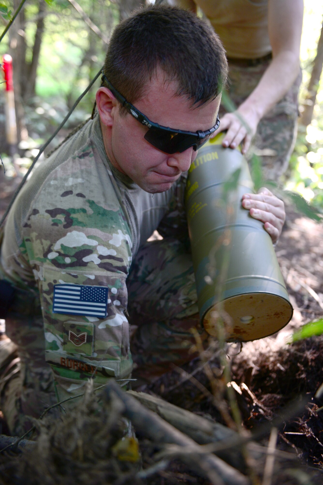 Staff Sgt. Jordan Burger, 2nd Civil Engineer Squadron explosive ordnance disposal technician, places an explosive for a controlled de-watering project in the east reservation woods at Barksdale Air Force Base, La., July 29, 2015. De-watering is important because it prevents flooding and the expansion of dangerous animals like alligators and venomous snakes. (U.S. Air Force Photo/Airman 1st Class Luke Hill)