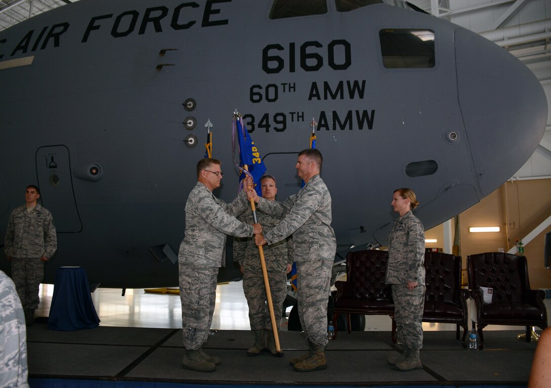 TRAVIS AIR FORCE BASE, Calif. -- Lt. Col. Joseph R. Orcutt relinquishes command of the 945th Aircraft Maintenance Squadron to Lt. Col. Arianne Mayberry, formerly the commander of the 349th Maintenance Operations Section, July 25, 2015 on Travis Air Force Base. (U.S. Air Force photos/Senior Airman Madelyn Brown)
