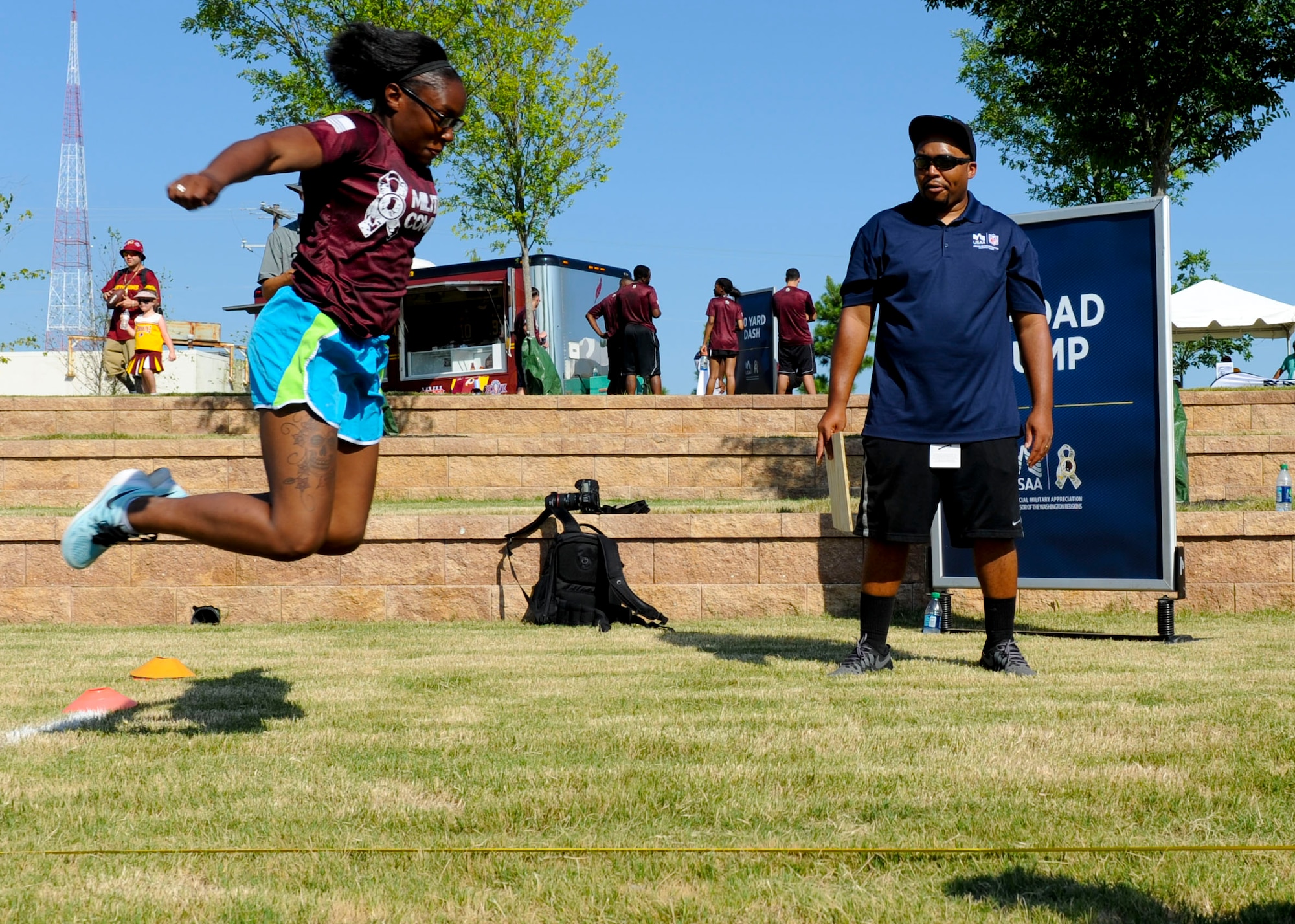 U.S. Army Pvt. Shanise Ferguson, 155th Inland Cargo Transportation Company fueler, performs a broad jump during the USAA and Washington Redskins Military Combine at the Bon Secours Training Center in Richmond, Va., July 31, 2015. More than 50 Service members competed in the combine. (U.S. Air Force photo by Staff Sgt. John D. Strong II/Released)