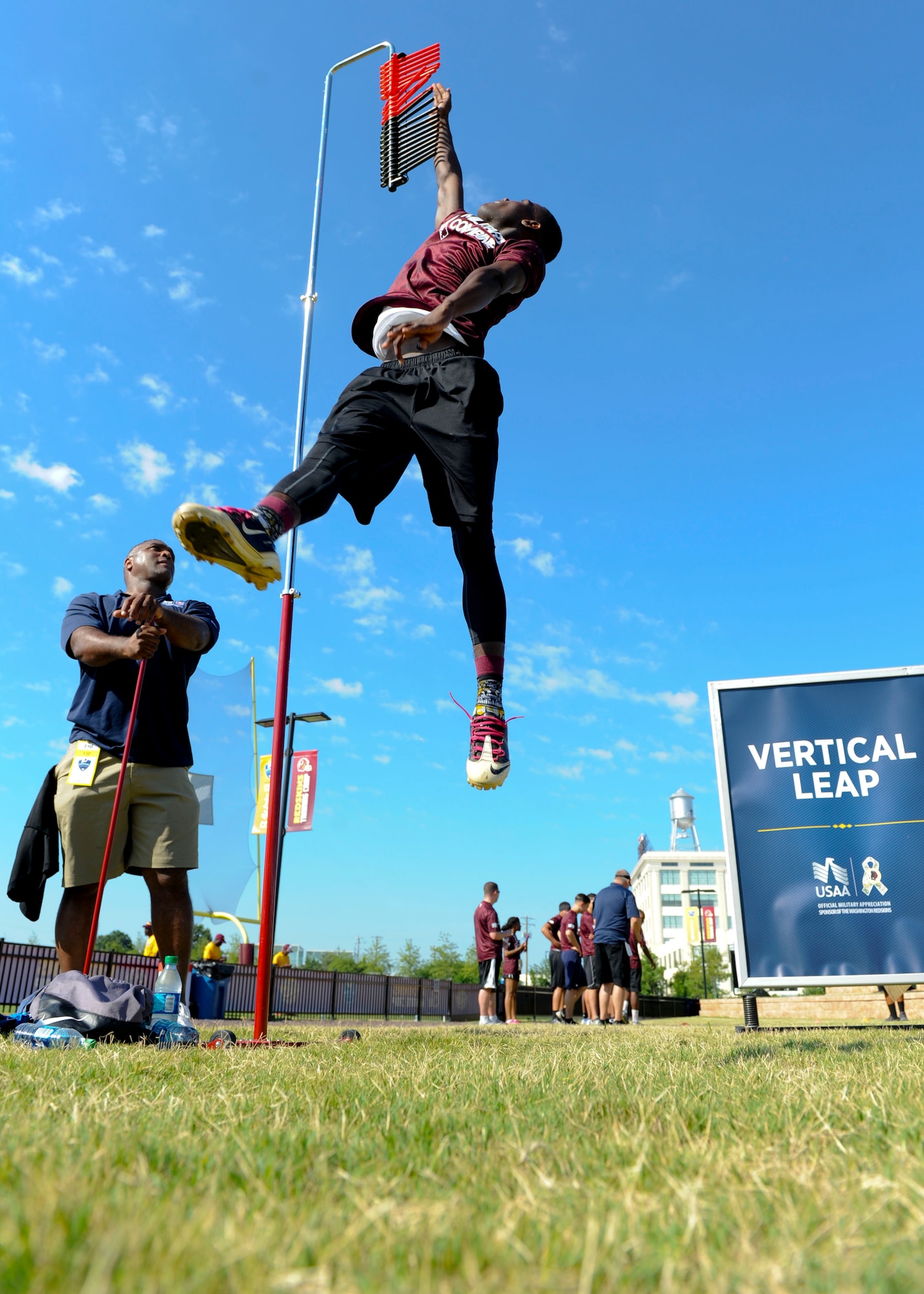 U.S. Air Force Airman 1st Class Dakota, 36th Intelligence Squadron geospatial intelligence analyst, performs a vertical leap during the USAA and Washington Redskins Military Combine at the Bon Secours Training Center in Richmond, Va., July 31, 2015. Dakota reached the 10.6 foot mark during his leap, one of the best scores in the combine. (U.S. Air Force photo by Staff Sgt. John D. Strong II/Released)
