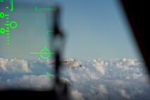 Two C-17 Globemaster III fly through the sky during Warrior Day, a day dedicated to demonstrate the cooperation and capabilities of total force integration at Joint Base Pearl Harbor-Hickam, Hawaii, July 31, 2015. The training was aimed to test the ability for the members of different squadrons to work together to complete a mission.  (U.S. Air Force photo by 2nd Lt. Kaitlin Daddona/Released)

