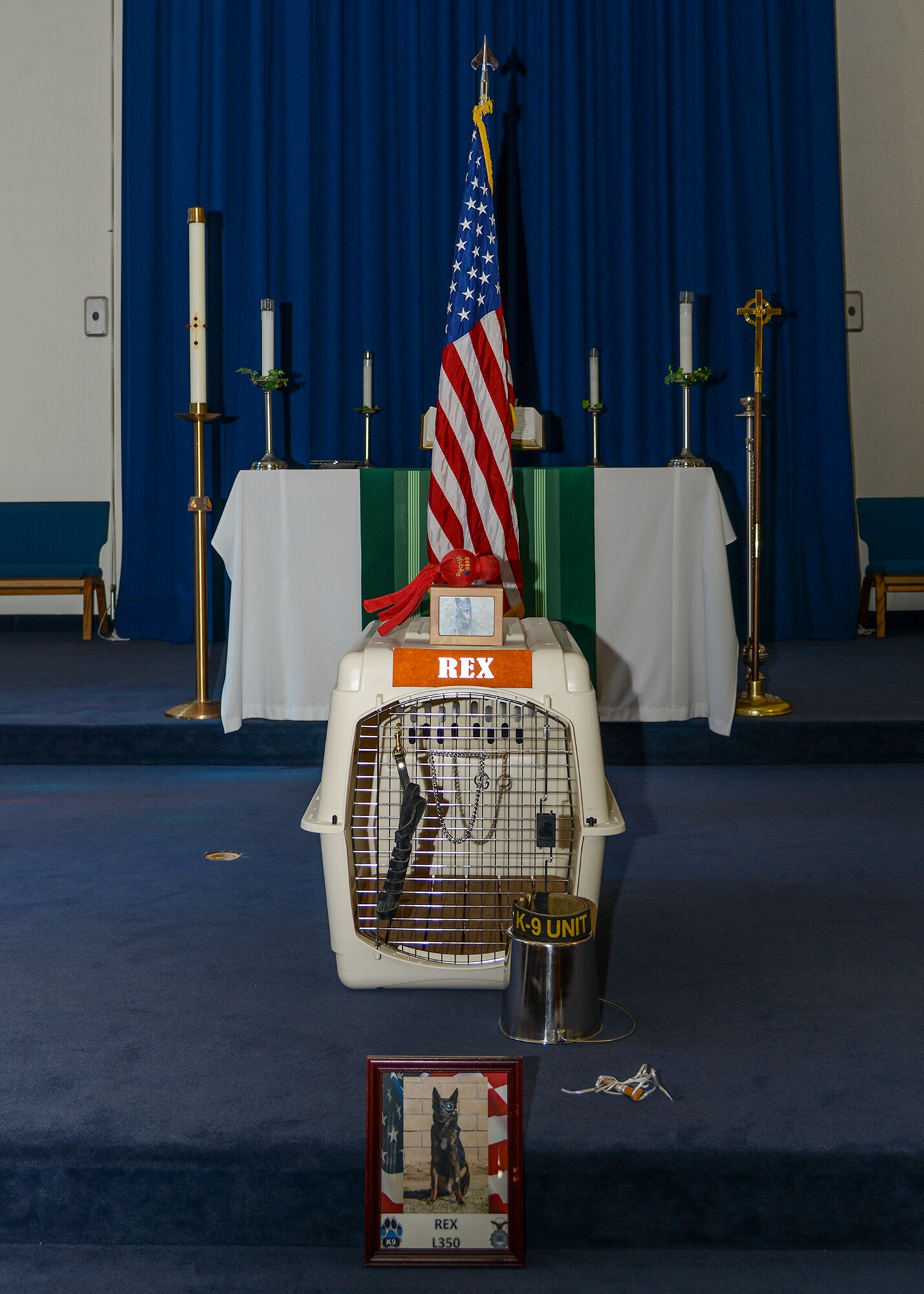 A display at the front of the chapel represented the bond between dog and handler. At the end of the service, a line formed in front of the display as people paid their final respects to Rex. (U.S. Air Force photo by Rebecca Amber)