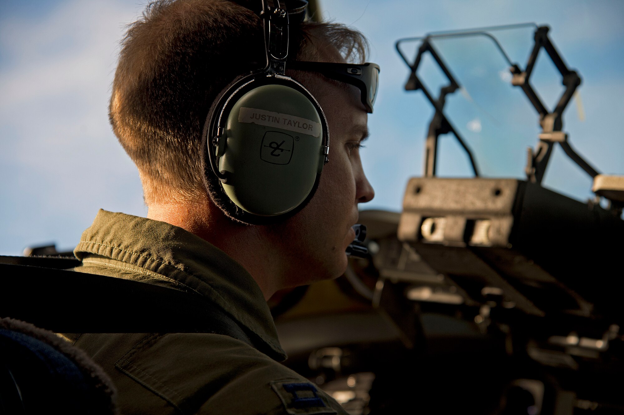 Capt. Justin Taylor, a C-17 Globemaster III pilot at the 535th Airlift Squadron, flies his aircraft during Warrior Day, a day dedicated to demonstrate the cooperation and capabilities of total force integration at Joint Base Pearl Harbor-Hickam, Hawaii, July 31, 2015. Air Force active duty and Air National Guard Airmen joined forces to complete a mission scenario to test the ability for the aircrafts and personnel to work together. (U.S. Air Force photo by 2nd Lt. Kaitlin Daddona/Released) 