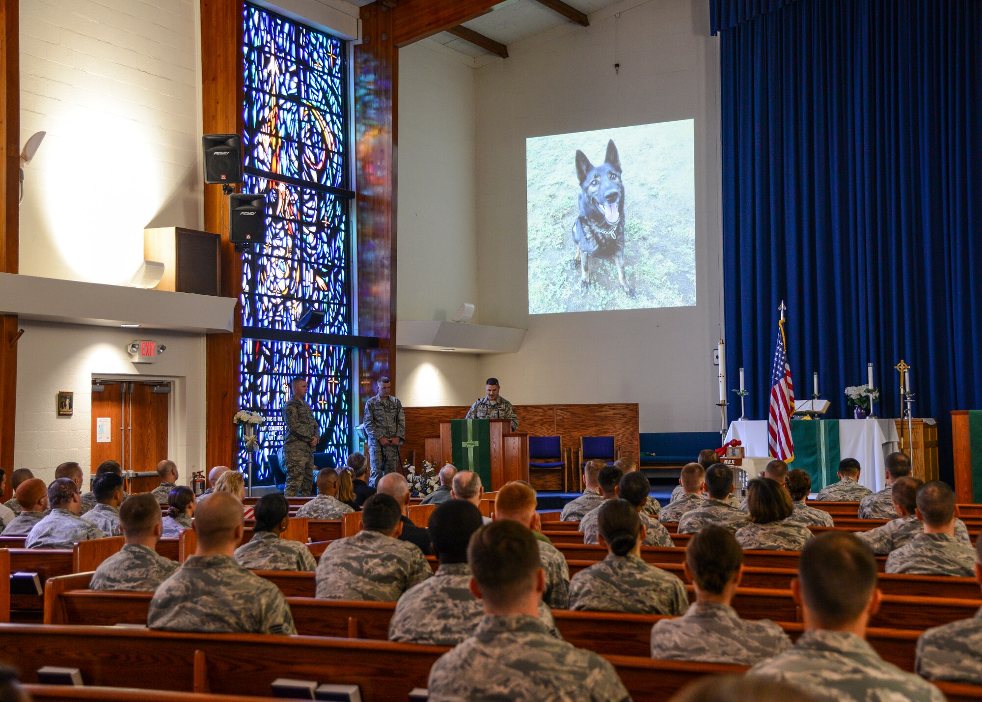 A Memorial Service for Military Working Dog Rex was held in Chapel 1 July 31. During the service he was honored with the reading of two poems, “I Wait by the Gate” and “Guardians of the Night.” (U.S. Air Force photo by Rebecca Amber)