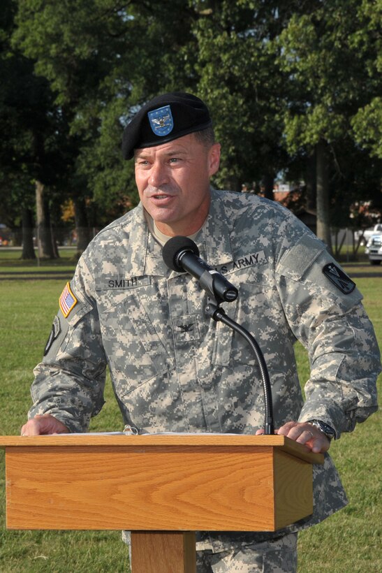 U.S. Army Col. John Smith, 128th Aviation Brigade incoming commander, speaks during his change of command ceremony at Fort Eustis, Va., July 30, 2015. Assuming command from Col. Julius Rigole, 128th Avn. Bde. outgoing commander, Smith joins the brigade from the Air Land Sea Application Center as their director at Langley Air Force Base, Va. (Courtesy photo)  