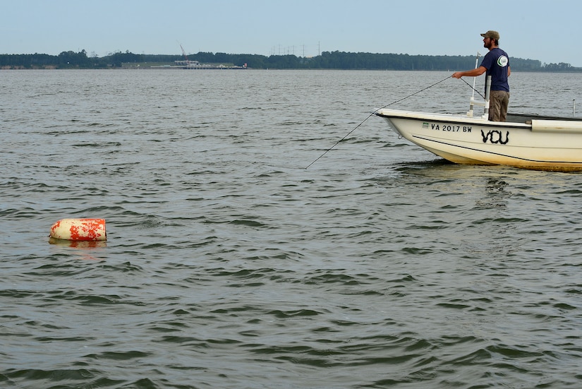 Matt Balazik, Virginia Commonwealth University Rice River Center researcher, reels out a gill net at Fort Eustis, Va., July 28, 2015. The gill net is designed to catch sturgeons in an effort to track their spawning habits. (U.S. Air Force photo by Senior Airman Kimberly Nagle/Released)  