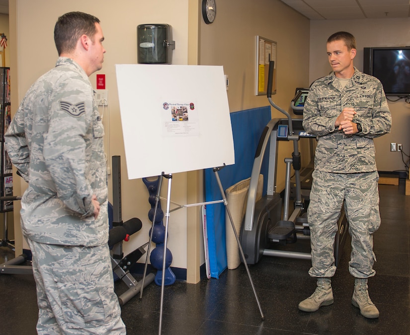 Captain Josh Van Wyngaarden (right), the 628th Medical Group Physical Therapy flight commander , prepares for a meeting with a distinguished visitor with Staff Sgt. Jake Wielgosiek, the physical medicine technician, July 28, 2015, in the 628 MDG. Coincidently, Van Wyngaarden and Wielgosiek have been stationed together for their only two duty stations. (U.S. Air Force photo/ Thomas T. Charlton)