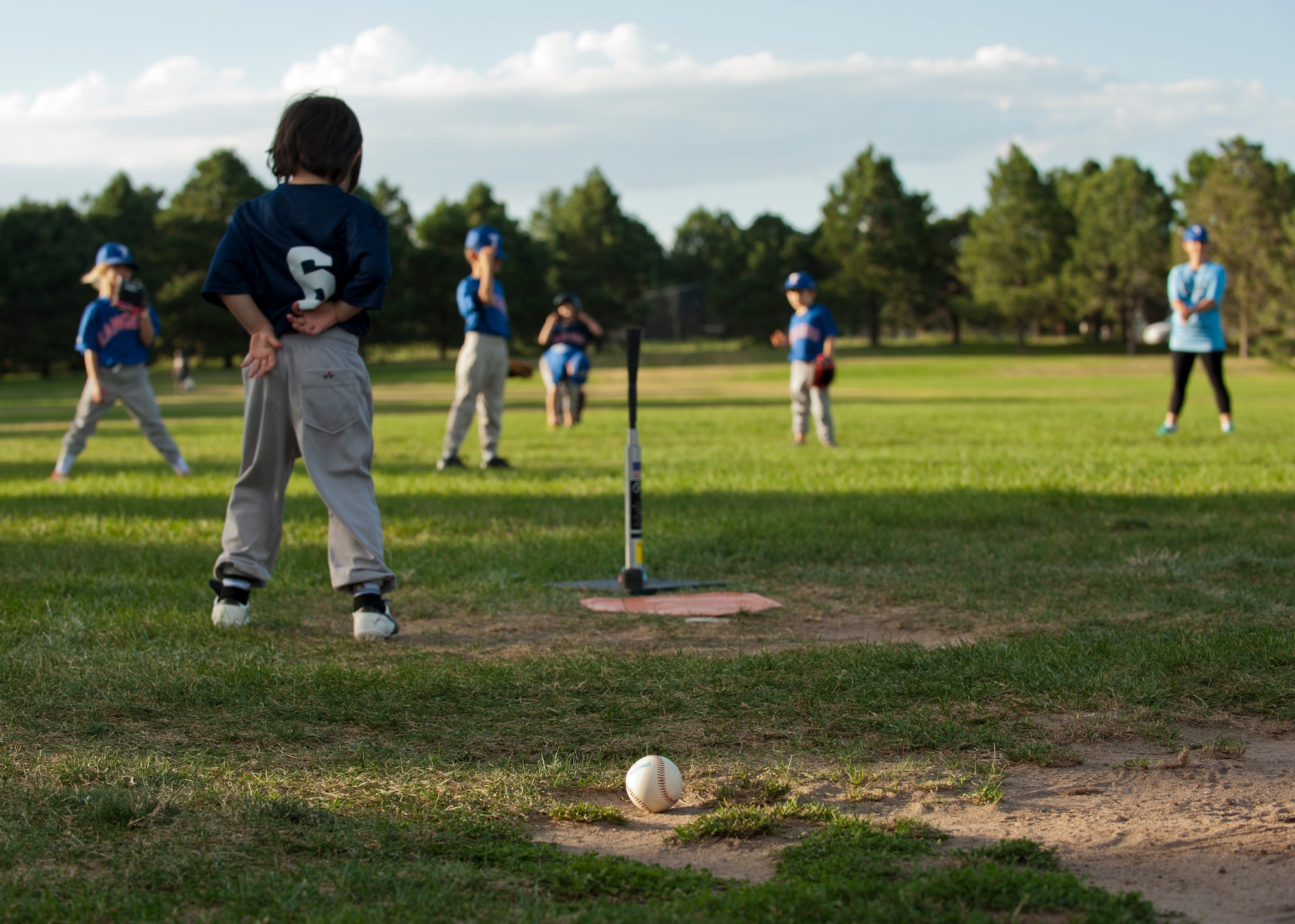 PETERSON AIR FORCE BASE, Colo. – Children who are part of the sports program at the R.P. Lee Youth Center wait for the next batter to step up to the plate at Patriot Park, July 28, 2015. The program is very family friendly and inclusive in that children who have special needs should have no fear of being excluded or singled out. It’s all about learning the game and having fun. (U.S. Air Force photo by Airman 1st Class Rose Gudex)