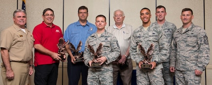 (from left to right) Navy Captain Timothy Sparks, the 628th air mobility wing deputy commander, John Gunther, chief antiterrorism officer with the 628th security forces squadron, Dominic Rend, lieutenant firefighter with the 628th civil engineer squadron, MSgt. Bradley L. Johnson, section chief for security systems at the 628th air mobility command, Joseph Gatti, civilian volunteer for the pharmacy at the 628th medical group, A1C Thomas Grimes, mobile equipment operator with the 628th logistics readiness squadron, 1st Lt. Daniel Musleave, installation deployment officer at the 628th LRS, and CMSgt. Bronson, command chief of the 628th AMC pose for the 628th air mobility wing 2nd quarterly awards ceremony in the Charleston Club on Joint Base Charleston, Aug. 3, 2015. Two Airmen were unavailable to receive their awards, non-commissioned officer of the quarter, TSgt. Robert J. Milush, non-commissioned officer in charge of public health with the 628th AMC and honor guard member of the quarter, SrA Christopher Heflin, Journeyman for the 437th maintenance squadron.  (U.S. Air Force photo/ Thomas T. Charlton)