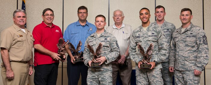 (from left to right) Navy Captain Timothy Sparks, the 628th air mobility wing deputy commander, John Gunther, chief antiterrorism officer with the 628th security forces squadron, Dominic Rend, lieutenant firefighter with the 628th civil engineer squadron, MSgt. Bradley L. Johnson, section chief for security systems at the 628th air mobility command, Joseph Gatti, civilian volunteer for the pharmacy at the 628th medical group, A1C Thomas Grimes, mobile equipment operator with the 628th logistics readiness squadron, 1st Lt. Daniel Musleave, installation deployment officer at the 628th LRS, and CMSgt. Bronson, command chief of the 628th AMC pose for the 628th air mobility wing 2nd quarterly awards ceremony in the Charleston Club on Joint Base Charleston, Aug. 3, 2015. Two Airmen were unavailable to receive their awards, non-commissioned officer of the quarter, TSgt. Robert J. Milush, non-commissioned officer in charge of public health with the 628th AMC and honor guard member of the quarter, SrA Christopher Heflin, Journeyman for the 437th maintenance squadron.  (U.S. Air Force photo/ Thomas T. Charlton)