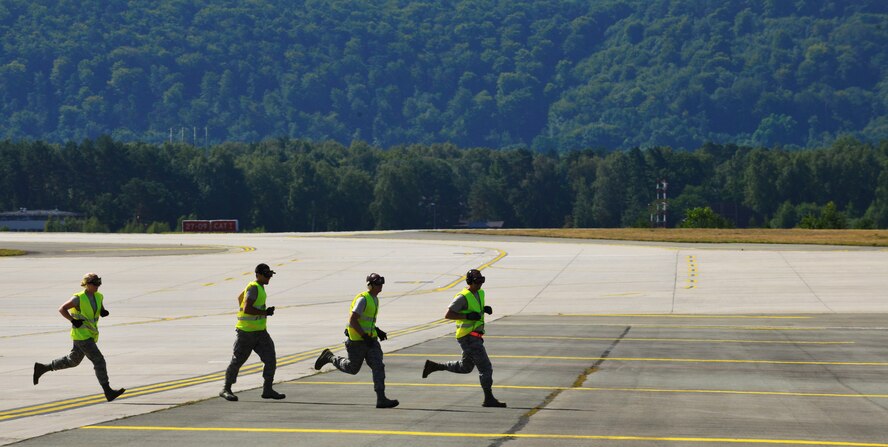 Airmen run on the flightline during the 2015 Ramstein Air Base Rodeo Aug. 1, 2015, at Ramstein Air Base, Germany.  The event is a competition aimed at showcasing the skills of the air transportation career field. (U.S. Air Force photo/Staff Sgt. Sharida Jackson)