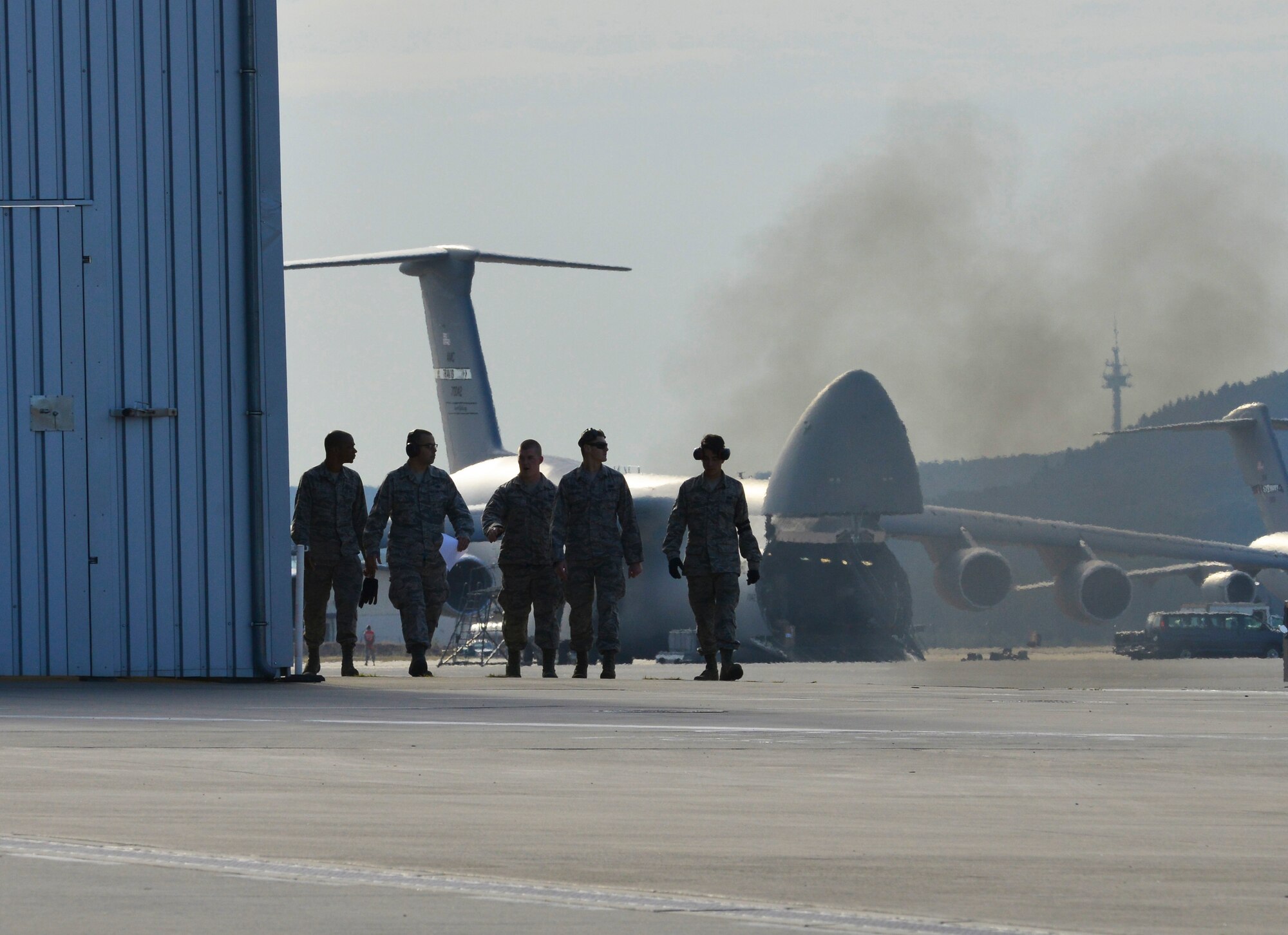 Members of the 721st Aerial Port Squadron fleet services team leave the flightline after completing the 60K forklift competition during the 2015 Ramstein Air Base Rodeo Aug. 1, 2015, at Ramstein Air Base, Germany. The event is a skills competition and includes events such as forklift operations, cargo pallet buildup, and an obstacle course. (U.S. Air Force photo/Staff Sgt. Sharida Jackson)