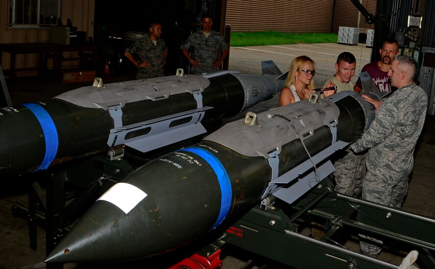 Heidi Liddell, spouse of retired American mixed martial artist Chuck “The Iceman” Liddell, assists with assembling a guided bomb unit-31 on Osan Air Base, South Korea, Aug. 5, 2015. The Liddell family visited various base units for demonstrations and to meet-and-greet with the Airmen during a morale trip, including the fire department, the fitness center and the munitions section. (U.S. Air Force photo/Senior Airman Kristin High)  