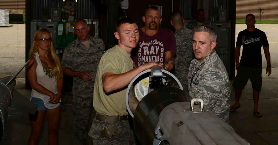 Staff Sgt. Layne Short, 51st Munitions Squadron flightline maintenance munitions inspector, Chuck “The Iceman” Liddell, retired American mixed martial artist, and Capt. Andrew Cooper, 51st MUNS munitions operations officer, assemble a guided bomb unit-31 on Osan Air Base, South Korea, Aug. 5, 2015. Liddell and his family visited various Osan units during a morale trip Aug. 2 – 5.   (U.S. Air Force photo/Senior Airman Kristin High)  