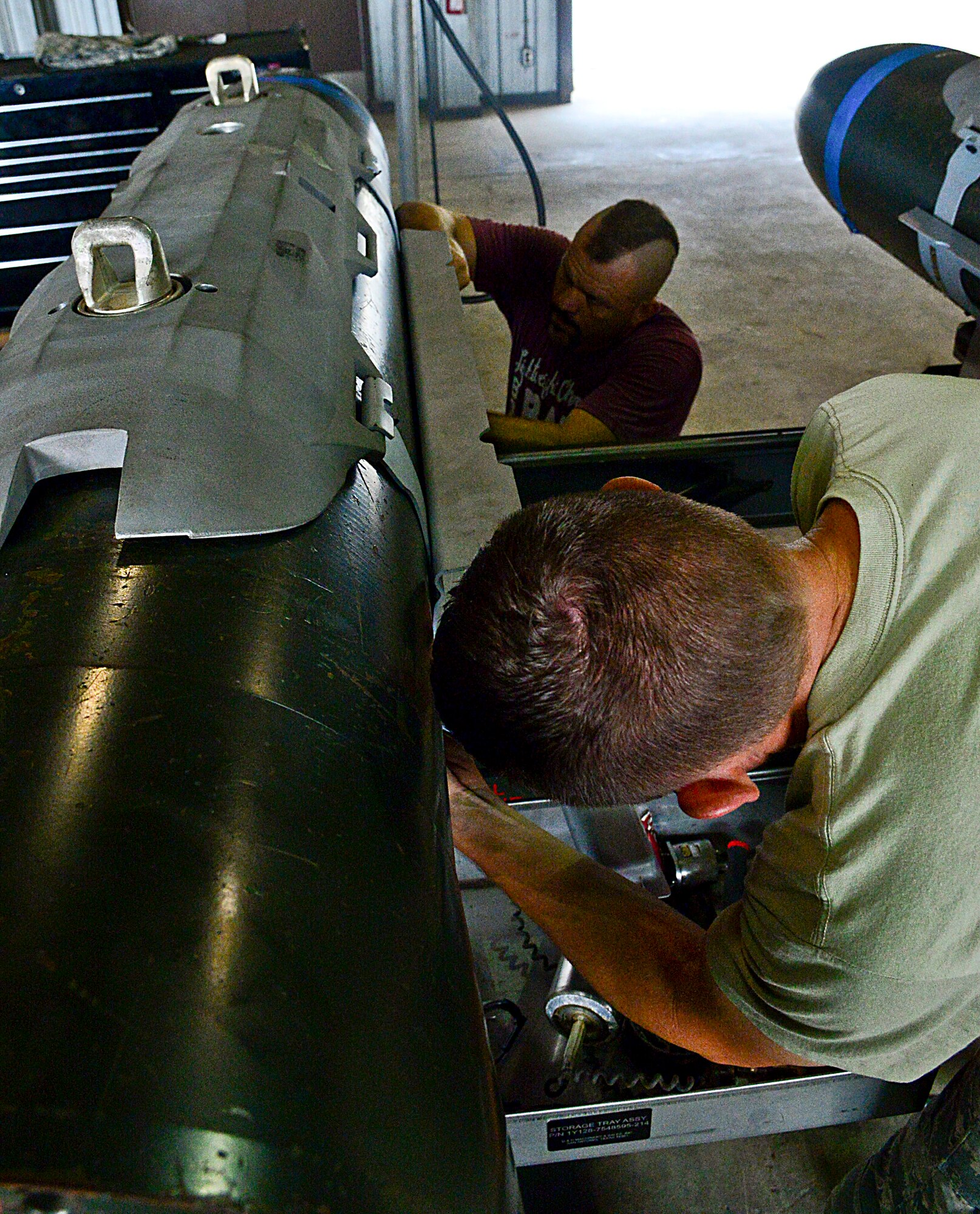Chuck “The Iceman” Liddell, retired American mixed martial artist, and Staff Sgt. Layne Short, 51st Munitions Squadron flightline maintenance munitions inspector, assemble a guided bomb unit-31 version 3 on Osan Air Base, South Korea, Aug. 5, 2015. With the assistance of 51st MUNS professional Airmen, Liddell and his family were able to help assemble three different types of GBUs used by the F-16 Fighting Falcons. (U.S. Air Force photo/Senior Airman Kristin High)