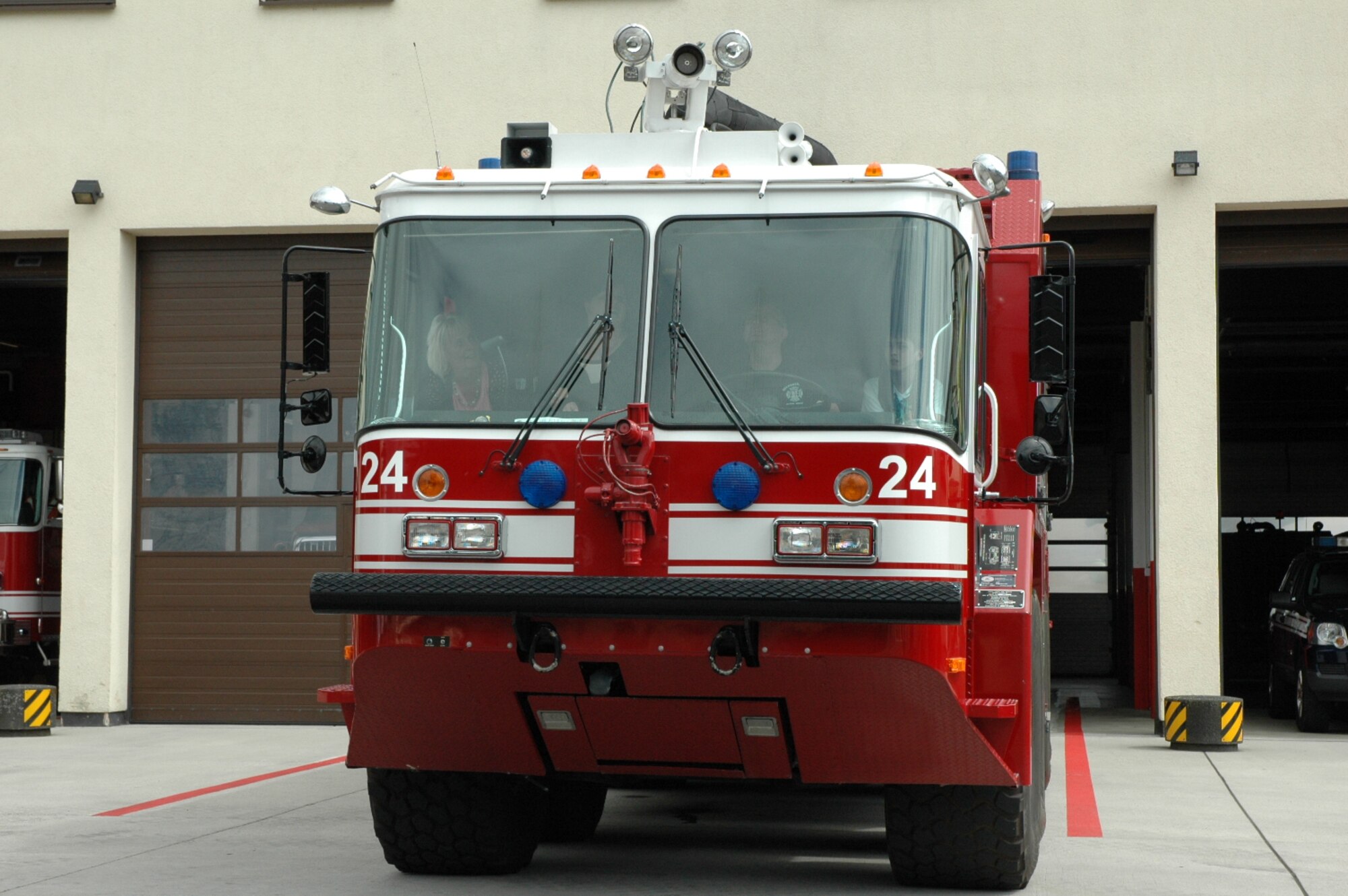 A 52nd Civil Engineer Squadron firetruck pulls out of a fire department garage during the Freundeskreis der Luftwaffe e.V. Association’s visit to Spangdahlem Air Base, Germany, July 13, 2015. The tour included sections of the 726th Air Mobility Squadron as well as sites from the 52nd Fighter Wing. (U.S. Air Force photo by Iris Reiff/Released)