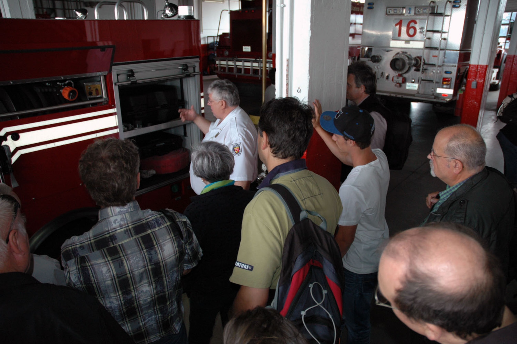 Philipp Recktenwald, a German fire inspector, presents the structures of a base fire truck to a group of members from the Freundeskreis der Luftwaffe e.V. Association during the association’s visit at Spangdahlem Air Base, Germany, July 13, 2015.The tour included sections of the 726th Air Mobility Squadron as well as sites from the 52nd Fighter Wing. (U.S. Air Force photo by Iris Reiff/Released)