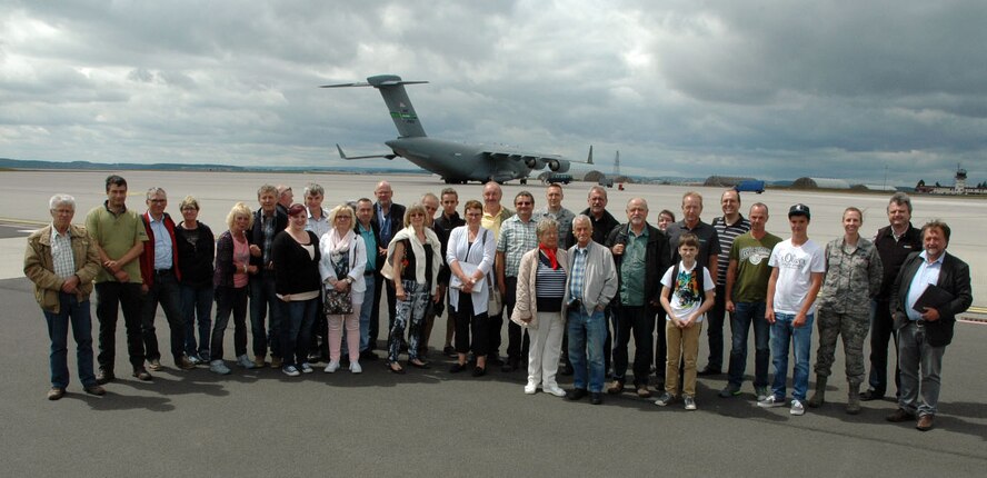 Members from the Freunde der Luftwaffe e.V.  Association pose for a group shot on the ramp at the 726th Air Mobility Squadron with a C-17 Cargo aircraft during the association’s visit of the 726th Air Mobility Squadron at Spangdahlem Air Base, Germany, July 13, 2015. The tour included sections of the 726th Air Mobility Squadron as well as sites from the 52nd Fighter Wing. (U.S. Air Force photo by Iris Reiff/Released)